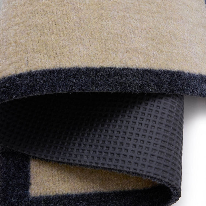 Close-up of a folded fabric with beige, black, and gray colors.