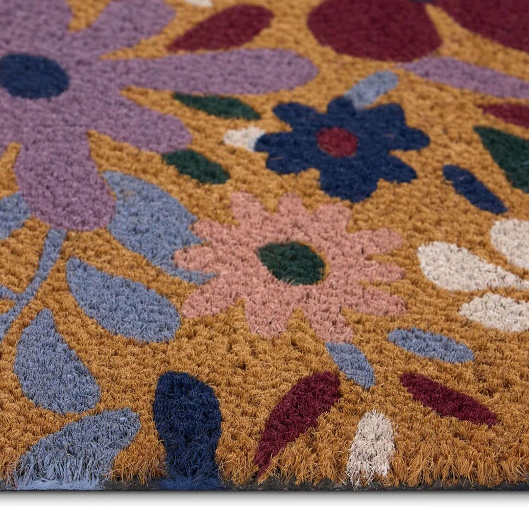 Close-up of a colorful floral-patterned rug with vibrant colors on a white background.