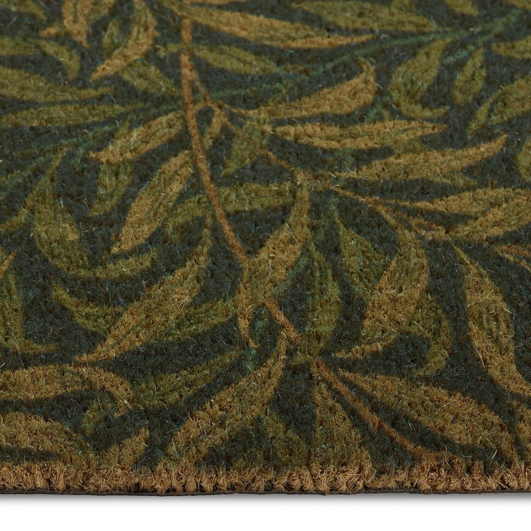 Close-up of a green leaf-patterned rug on a white background