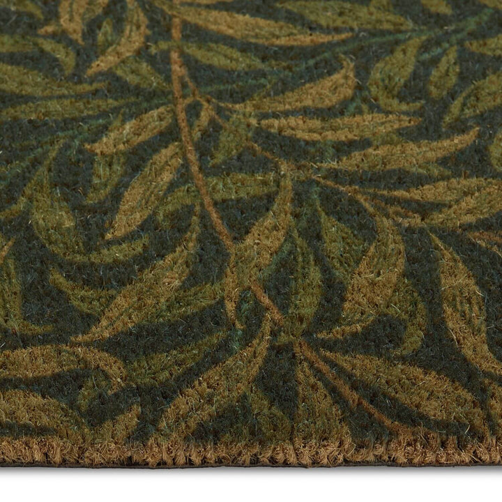 Close-up of a green leaf-patterned rug on a white background