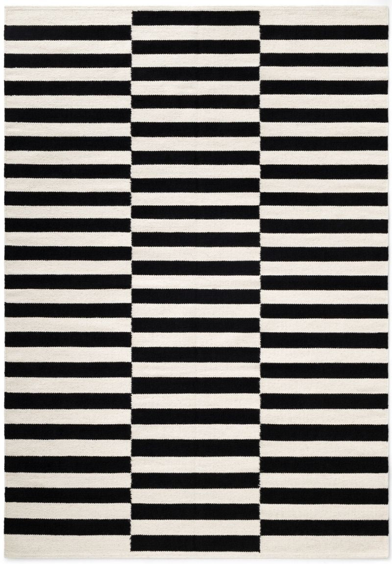 Striped black and white rug with vertical and horizontal lines