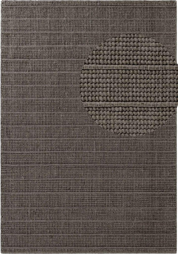 Textured brown rug with a circular pattern