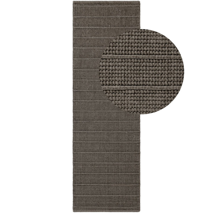 Brown textured bath mat with round rug inset on a white background