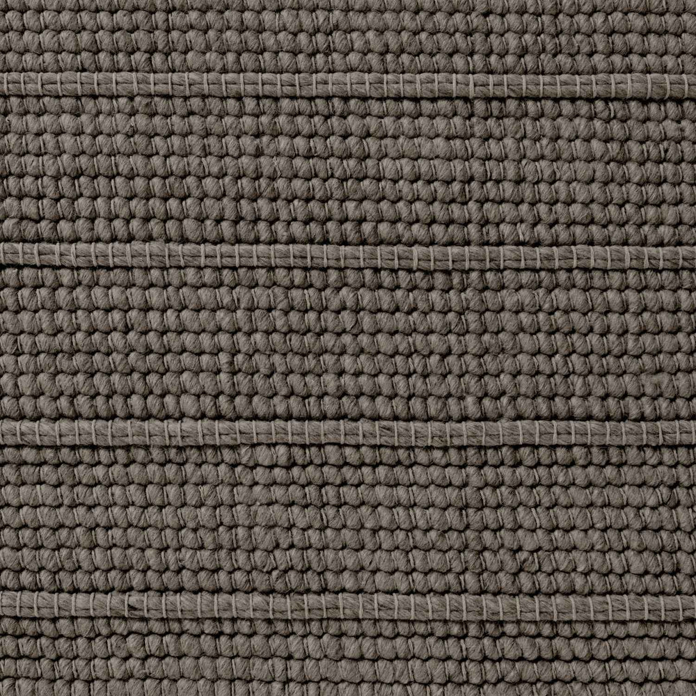 Close-up of a textured brown fabric surface