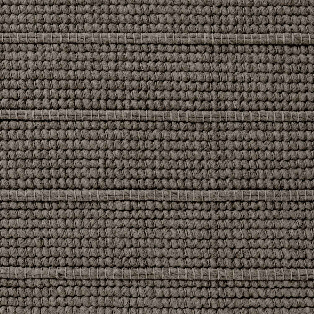 Close-up of a textured brown fabric surface