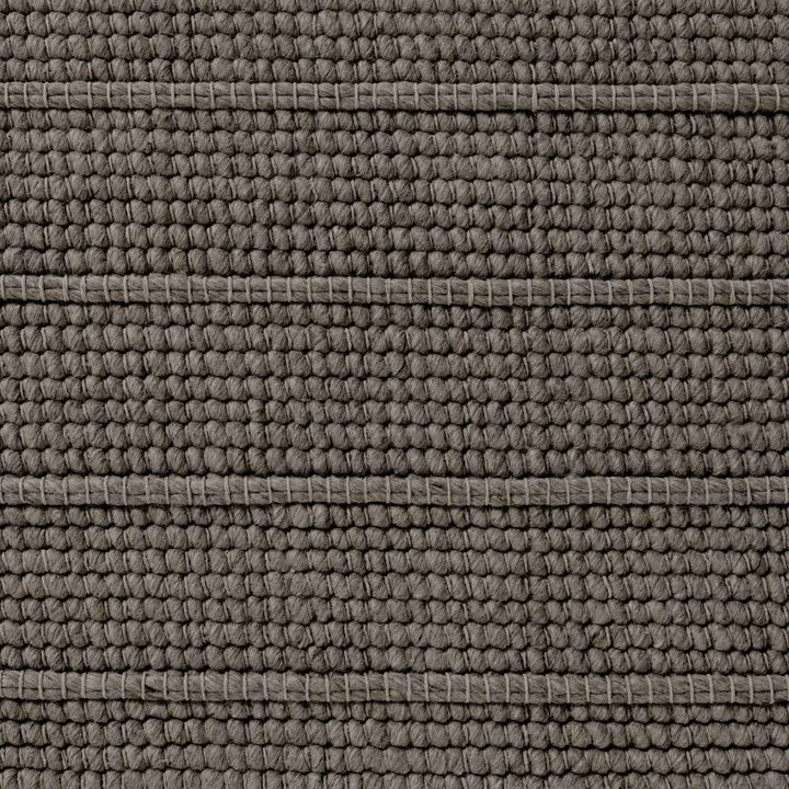 Close-up of a textured brown fabric surface