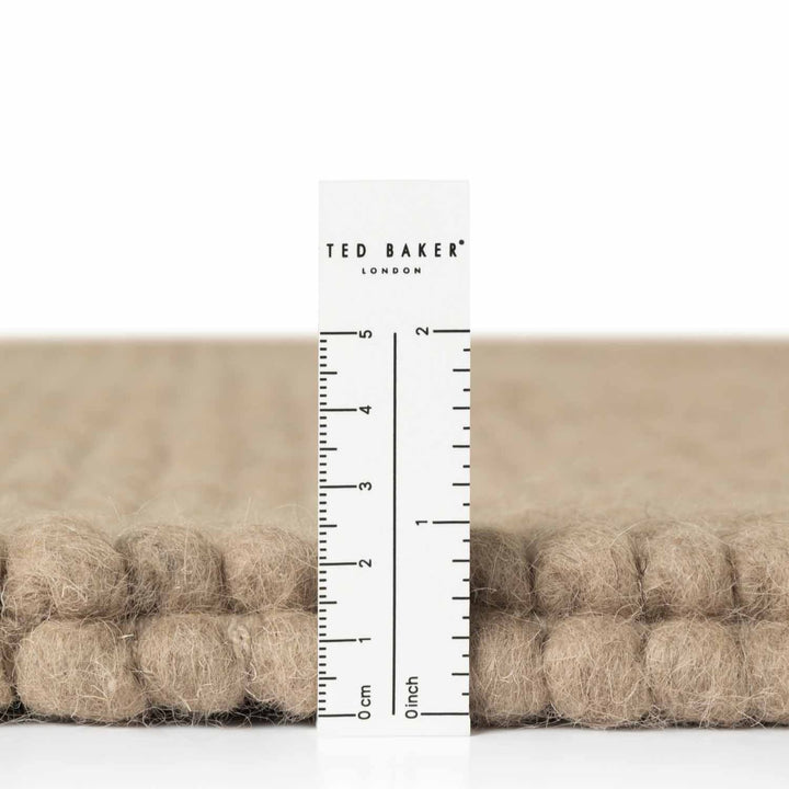 Ted Baker fabric swatch with a ruler for scale on a white background