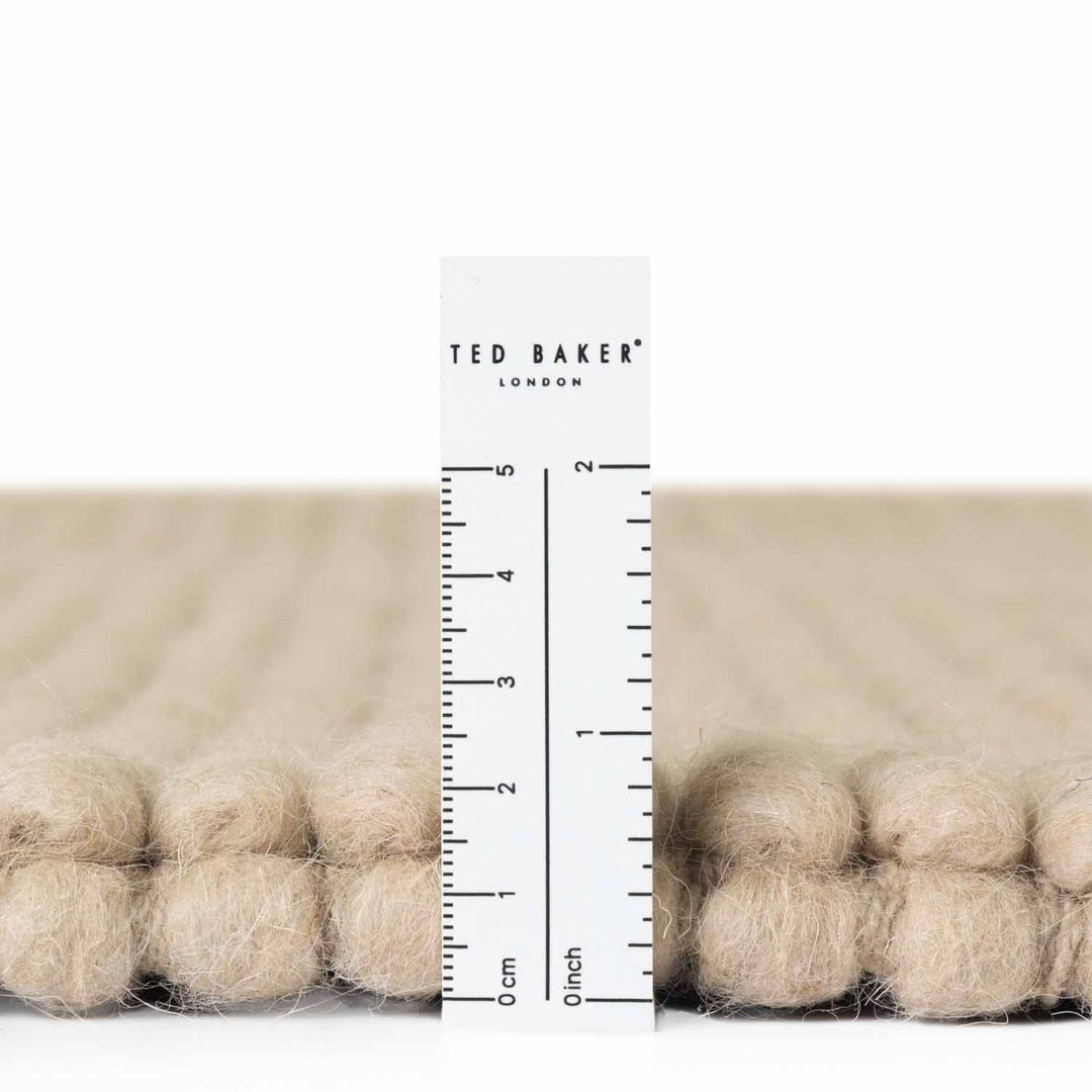 Beige fabric with a ruler and 'Ted Baker London' branding