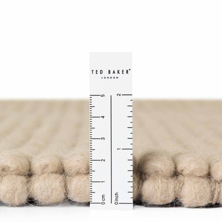 Beige fabric with a ruler and 'Ted Baker London' branding