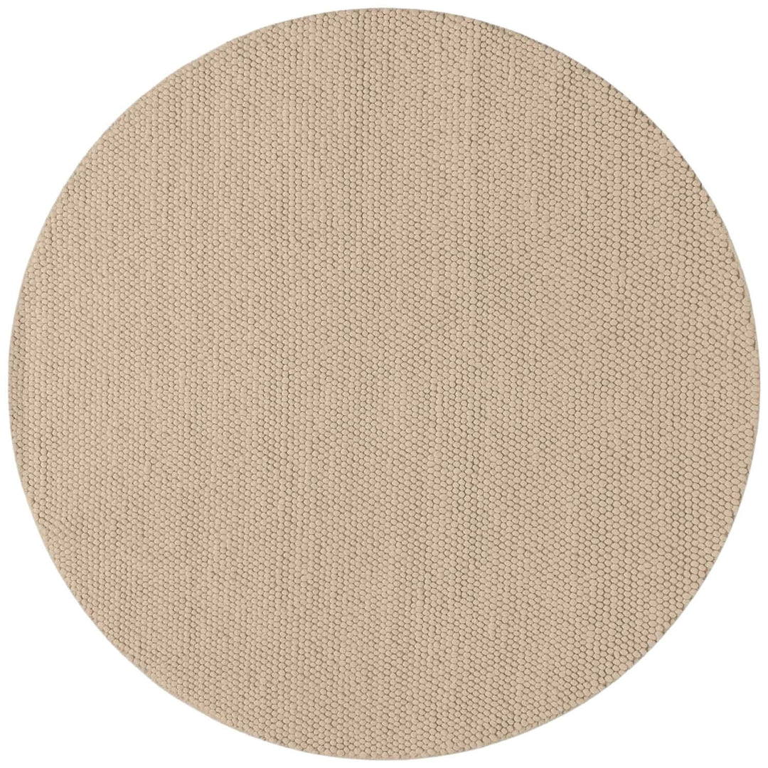 Beige round rug on a white background