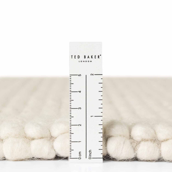 Packaged product with a ruler showing measurements, featuring the Ted Baker brand.