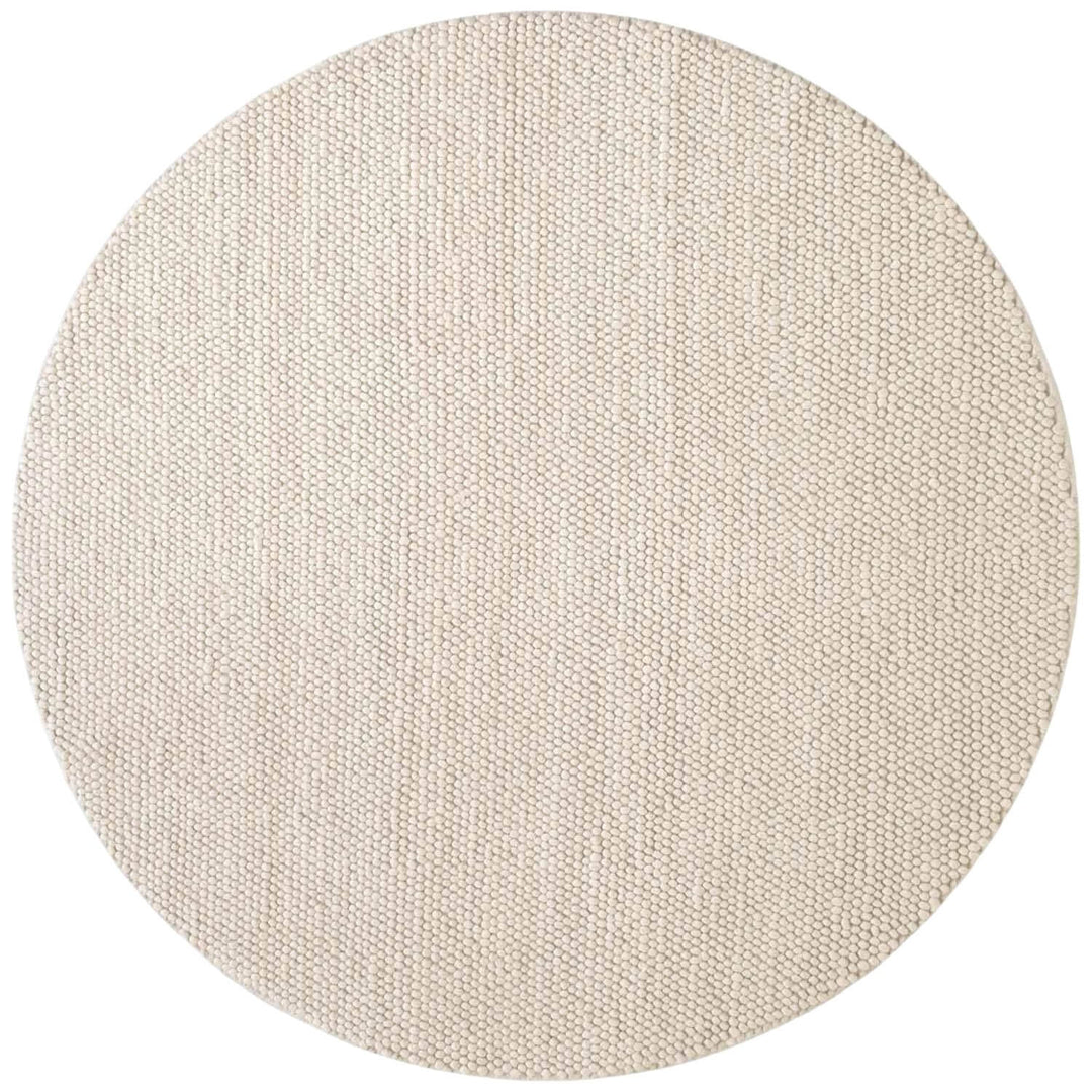 Round beige rug with a textured pattern on a white background