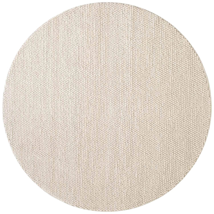 Round beige rug with a textured pattern on a white background