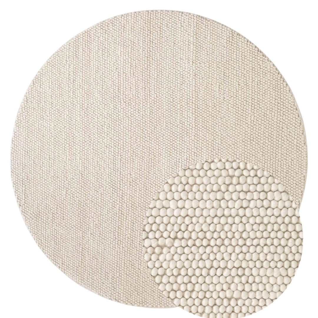 Round textured rug with a beaded border on a white background