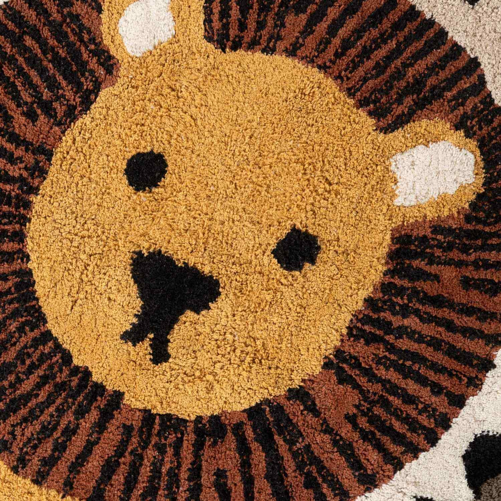 Round rug with a lion face design in brown, black, and beige colors.