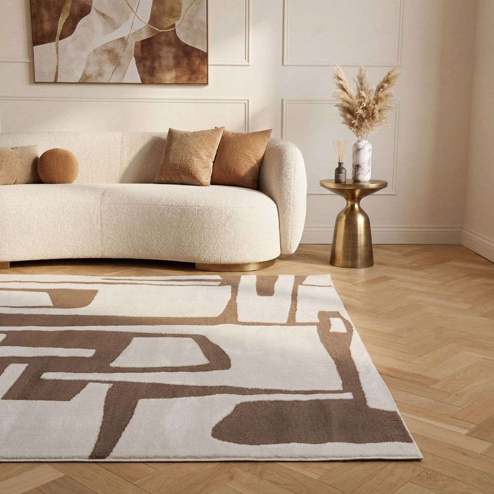 Living room with a beige sofa, abstract rug, and decorative elements.