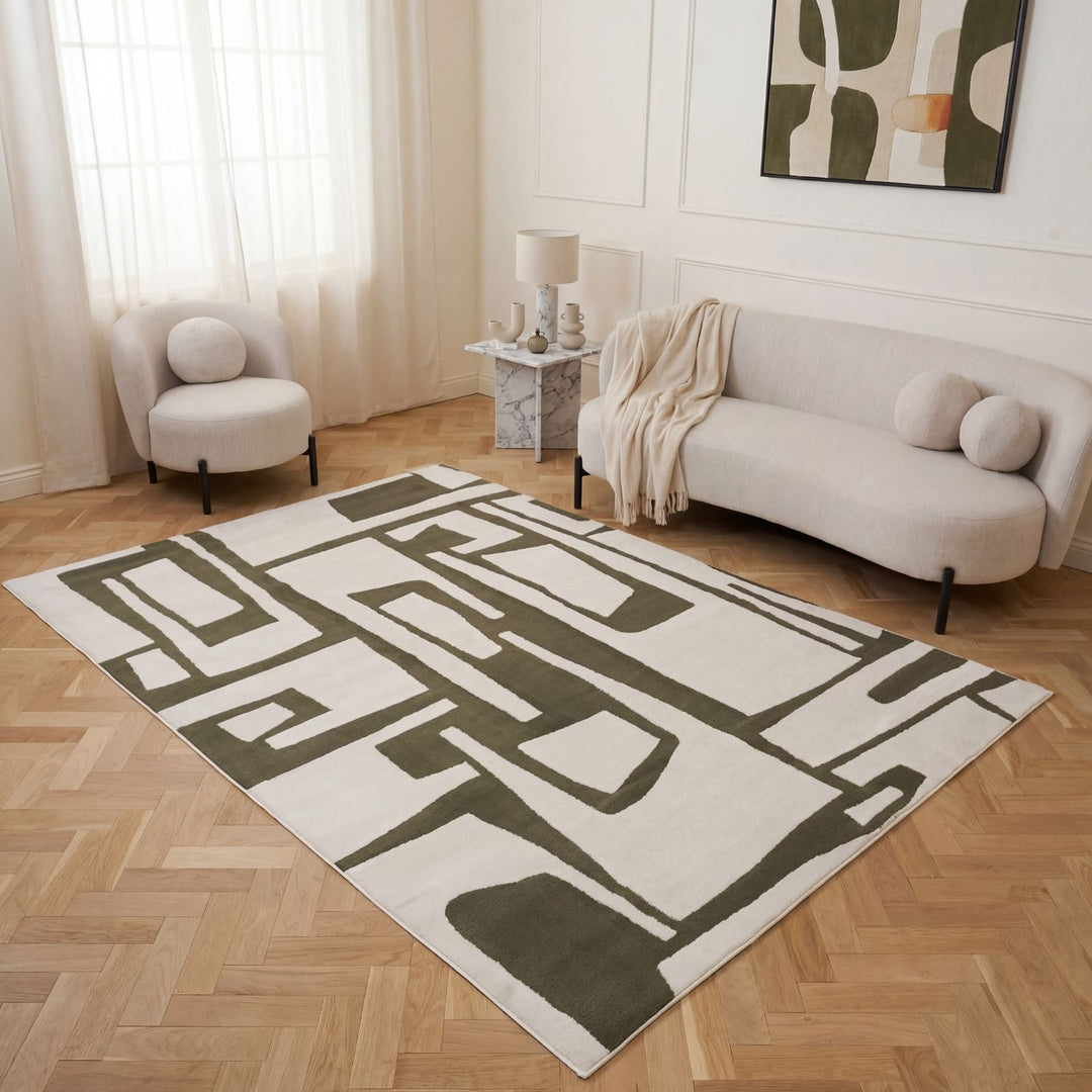 Geometric patterned rug on a wooden floor with a sofa and chair in a living room.