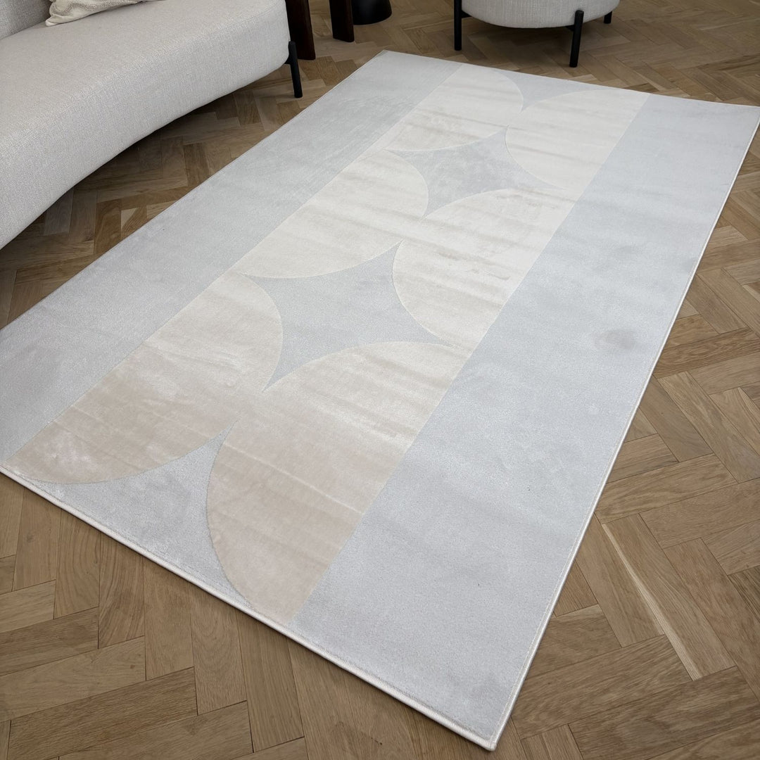 Rectangular area rug with abstract pattern on a wooden floor
