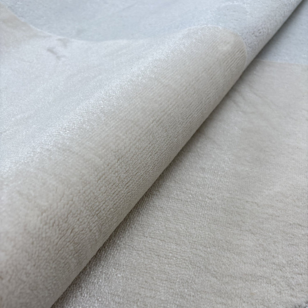 Close-up of textured beige fabric with a slight sheen