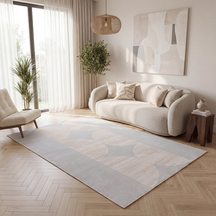 Modern living room with a beige sofa, rug, and abstract painting.