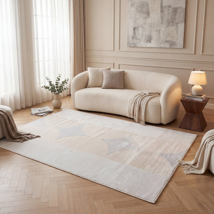 Modern living room with a beige sofa, geometric rug, and abstract art on the wall.
