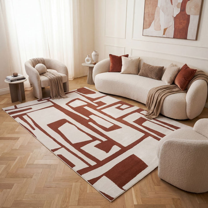 Living room with a patterned rug, sofa, and armchair.