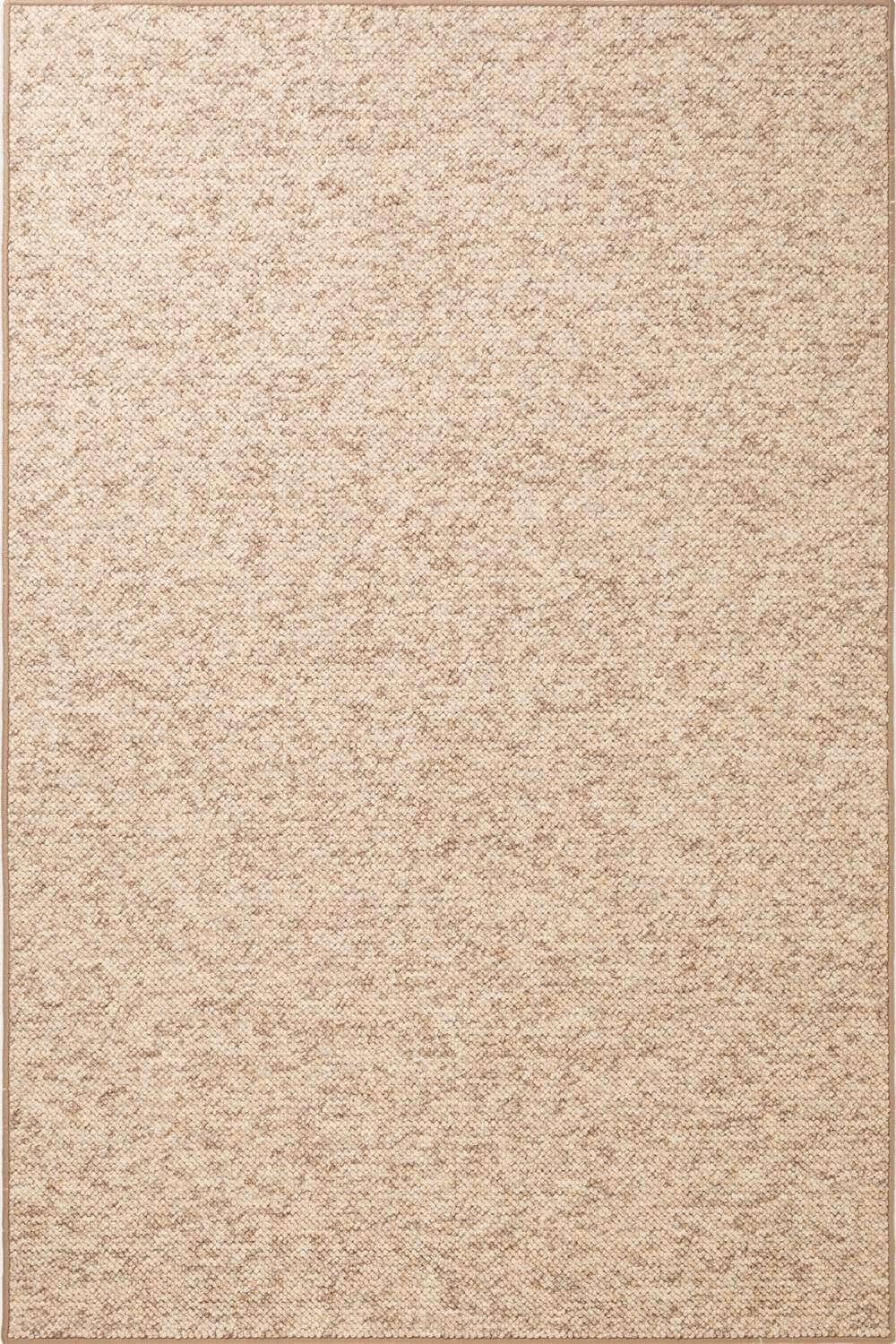Beige textured area rug with a subtle pattern