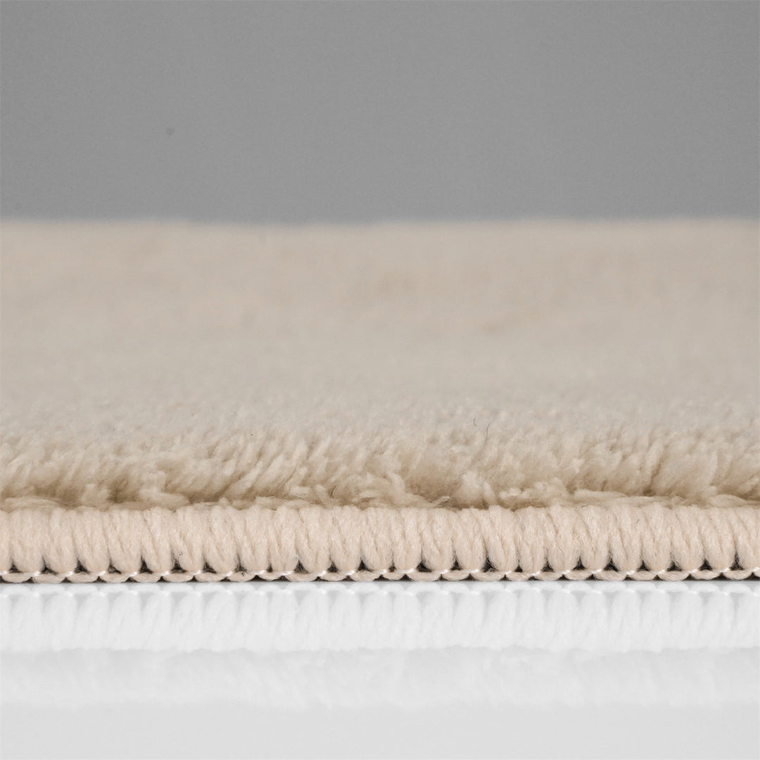 Washmellow beige washable rug, side view of the low pile and edge at floor level | The Rugs