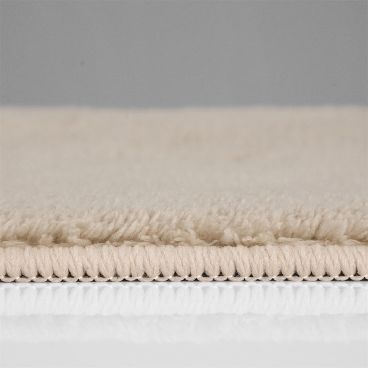 Washmellow beige washable rug, side view of the low pile and edge at floor level | The Rugs