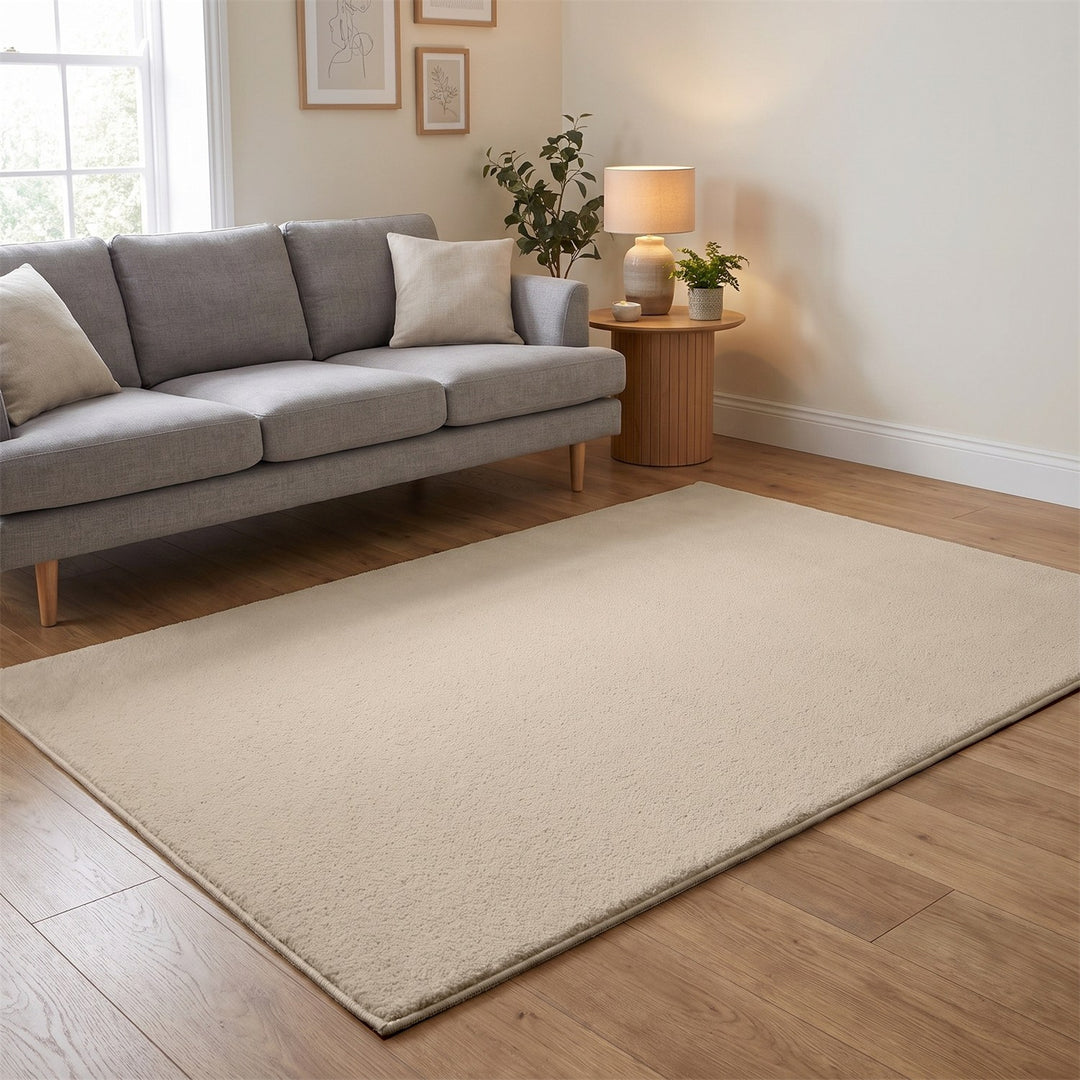 Washmellow beige washable rug in a living room with a grey sofa and oak floor | The Rugs