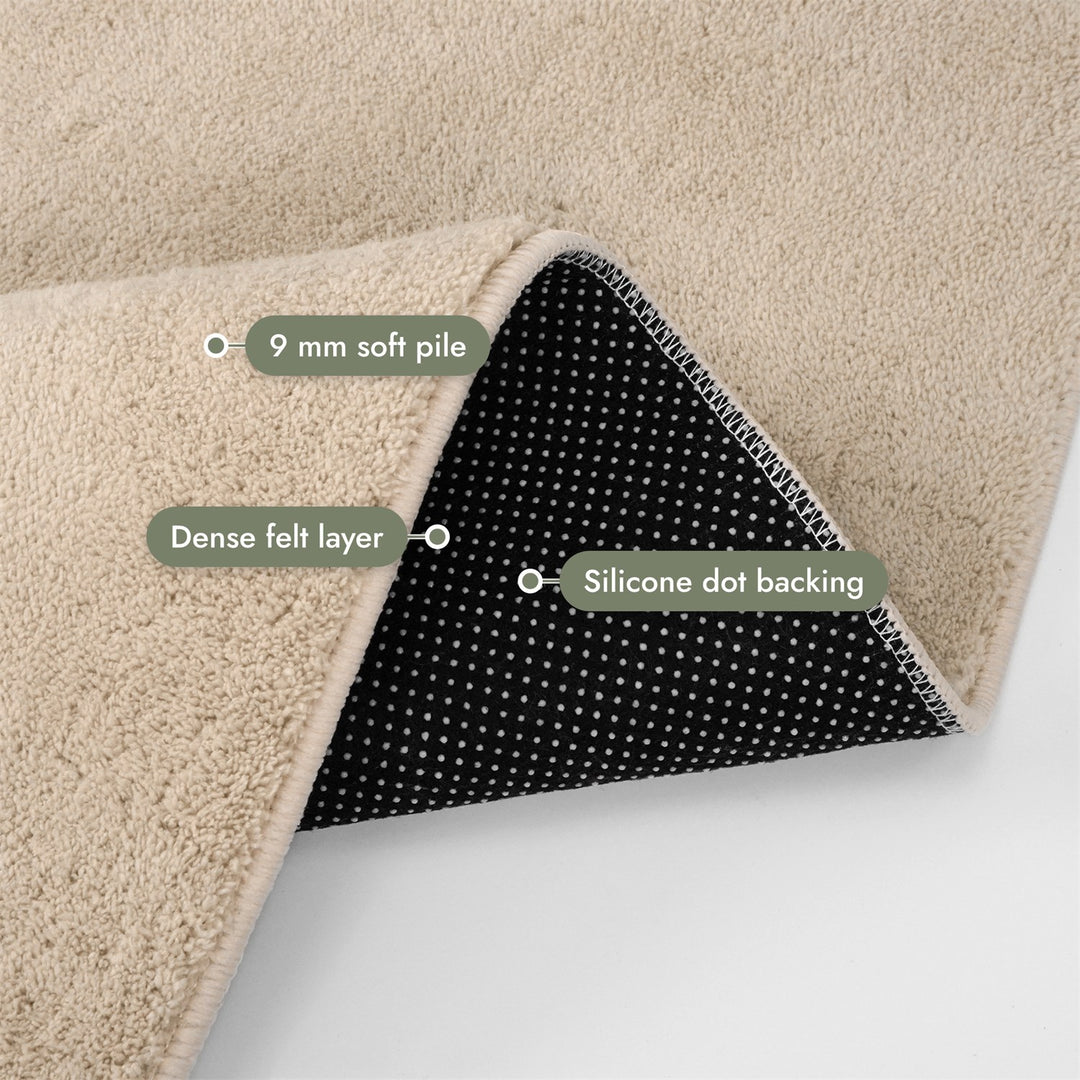Washmellow beige washable rug, folded corner showing the pile, felt layer and backing | The Rugs