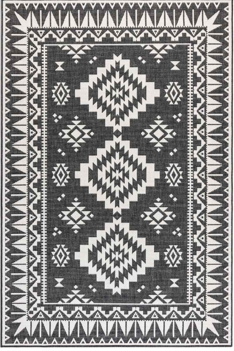 Black and white geometric patterned rug with tribal design