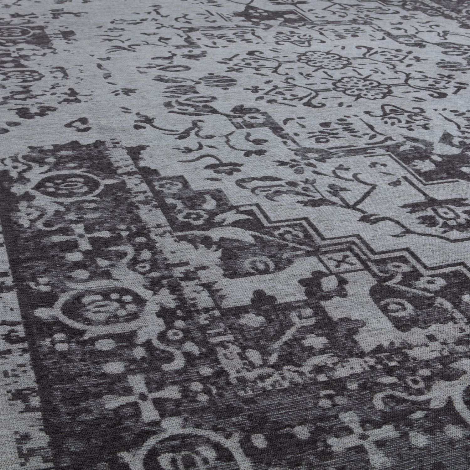 Close-up of a patterned rug with intricate designs.
