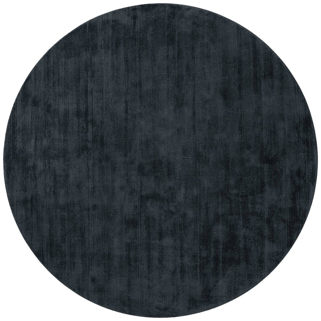 Round dark gray rug on a white background