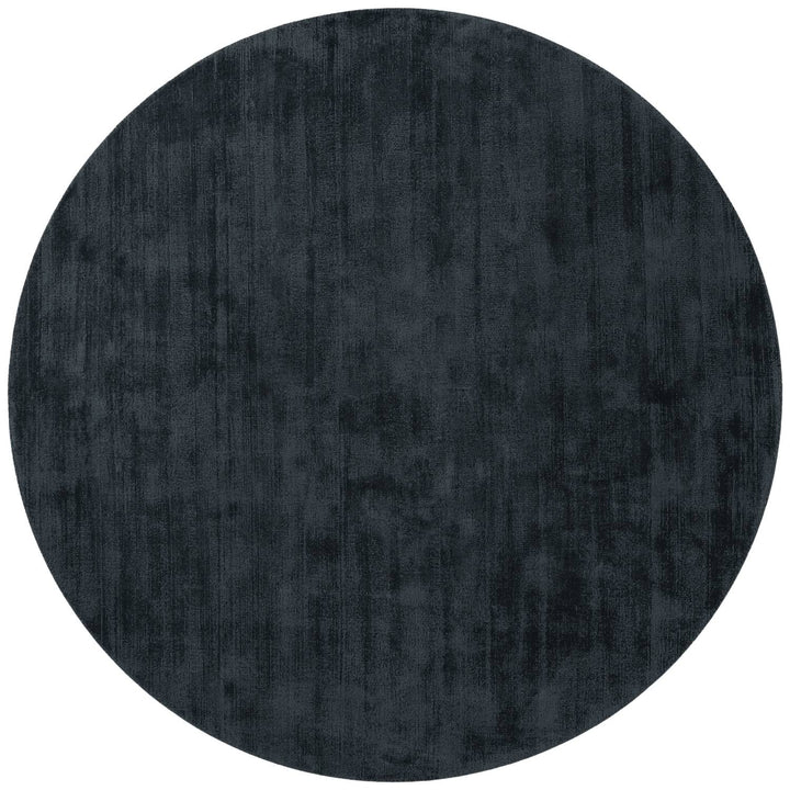 Round dark gray rug on a white background