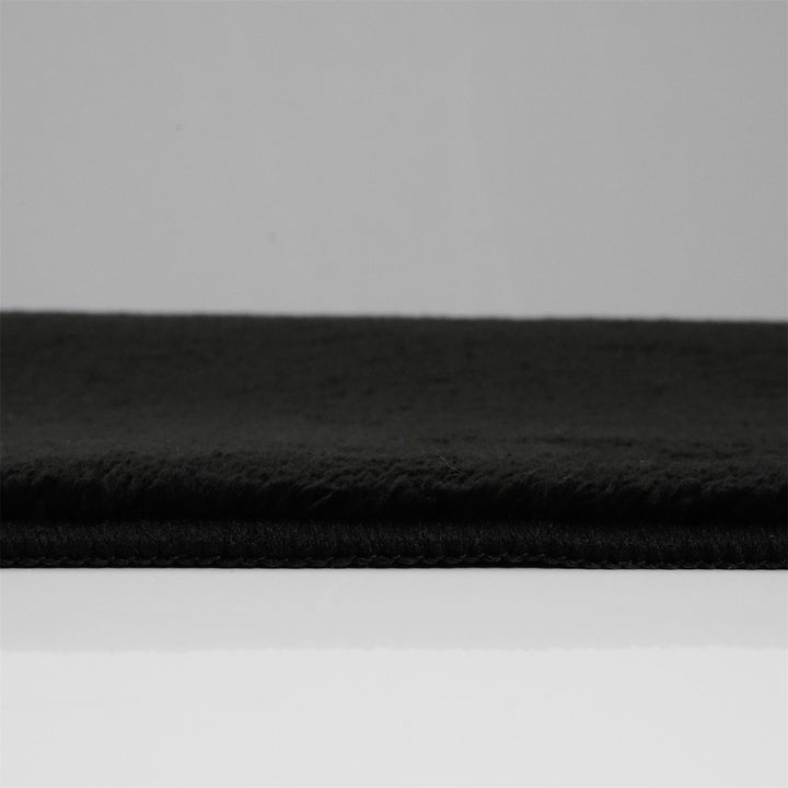 Washmellow black washable rug, side view of the low pile and edge at floor level | The Rugs