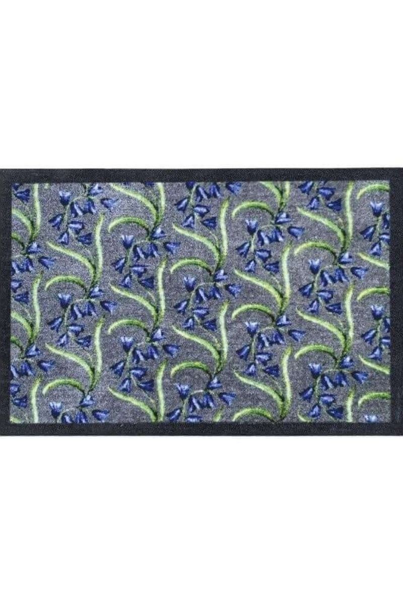 Doormat with blue floral pattern on a gray background