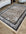 Decorative rug with intricate patterns on a wooden floor