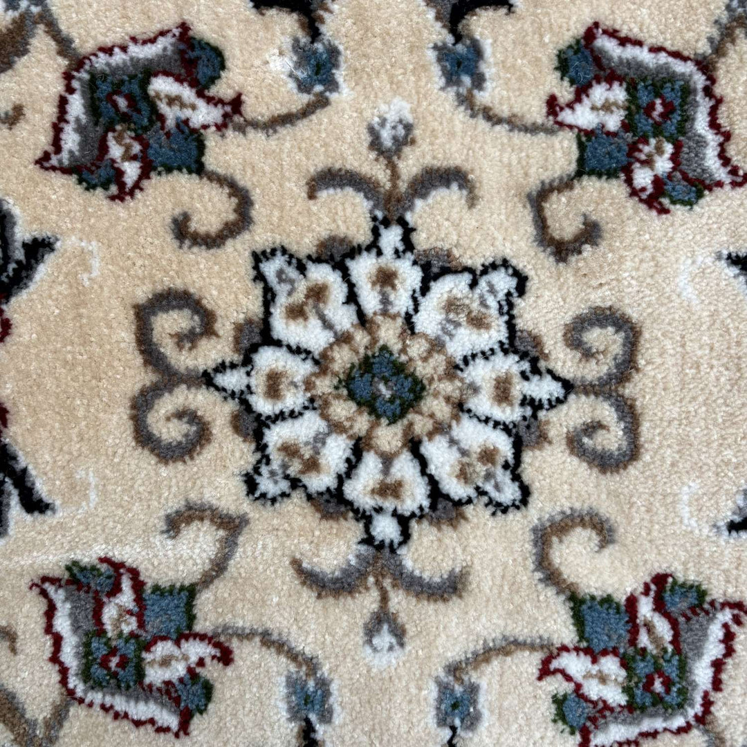 Close-up of a patterned rug with floral designs on a beige background
