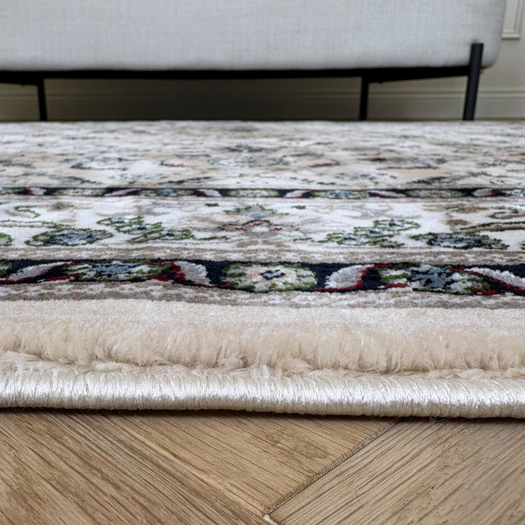 Patterned rug on a wooden floor with a neutral-colored sofa in the background