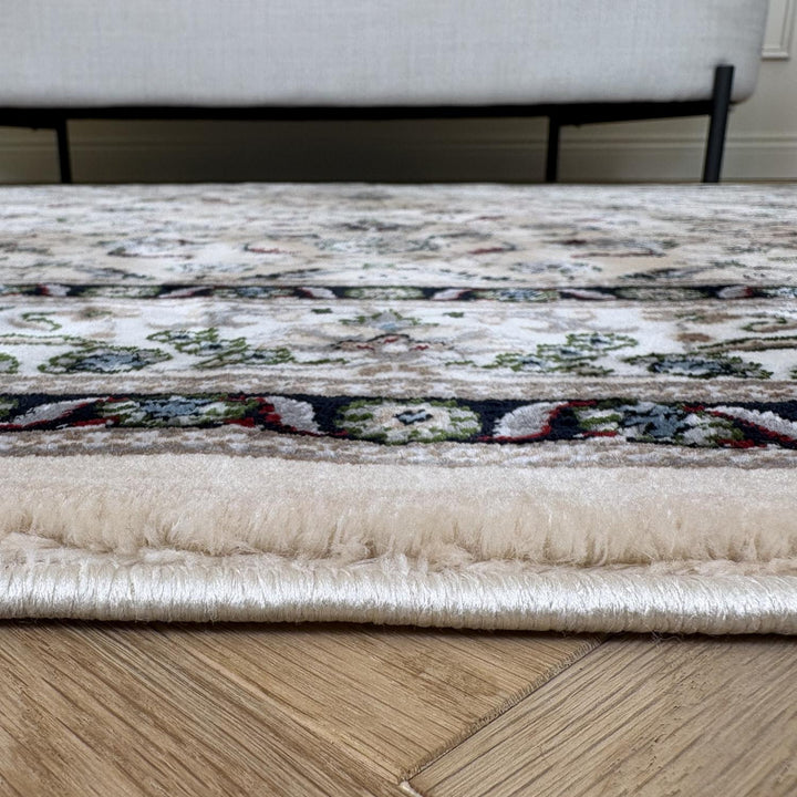 Patterned rug on a wooden floor with a neutral-colored sofa in the background