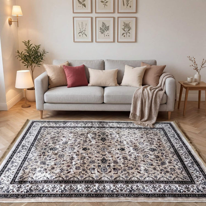 Living room with a gray sofa, patterned rug, and decorative elements.