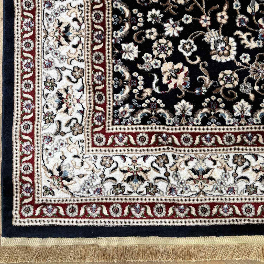 Close-up of a patterned rug with floral designs and intricate border.