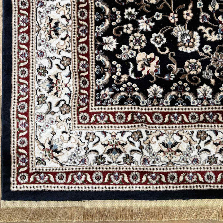 Close-up of a patterned rug with floral designs and intricate border.