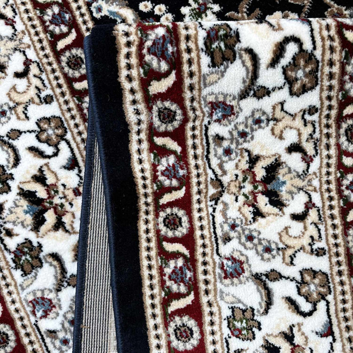 Close-up of a patterned rug with a black object on top