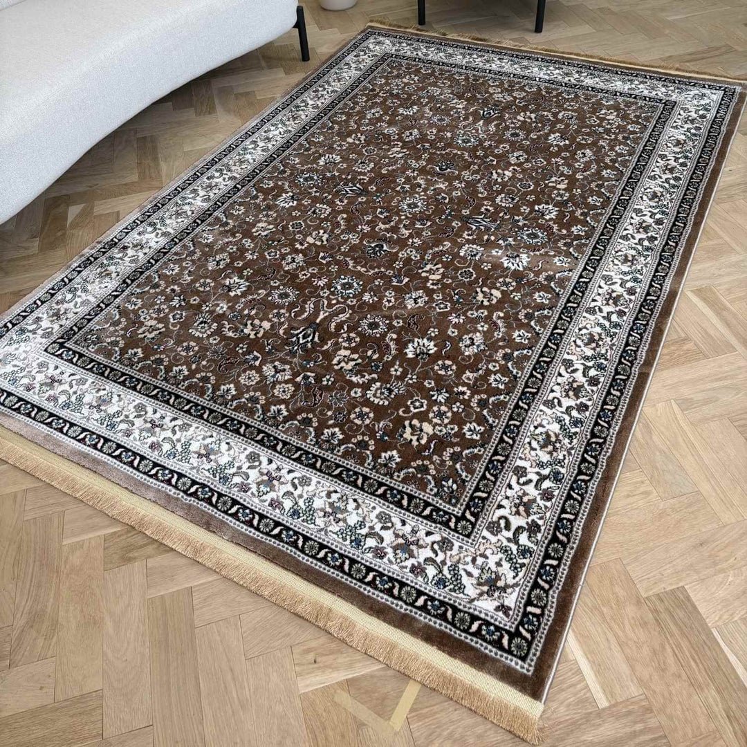 Decorative rug with intricate patterns on a wooden floor