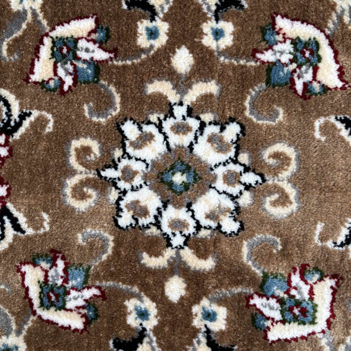 Close-up of a patterned rug with floral designs on a brown background
