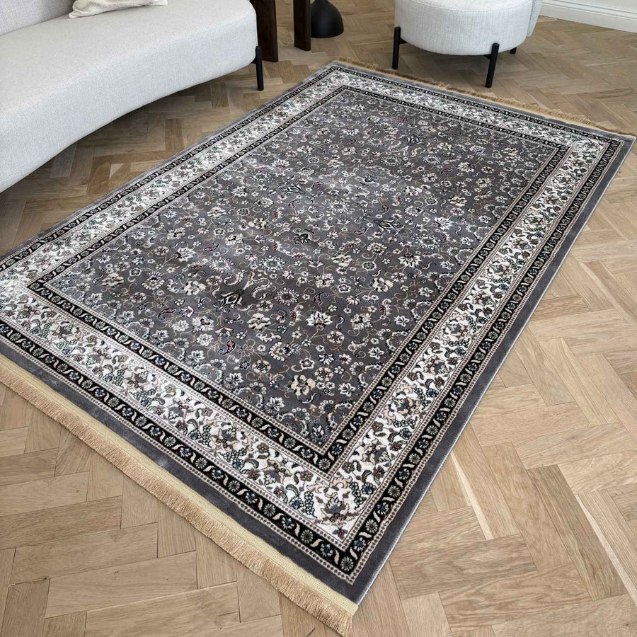 Decorative rug with intricate patterns on a wooden floor