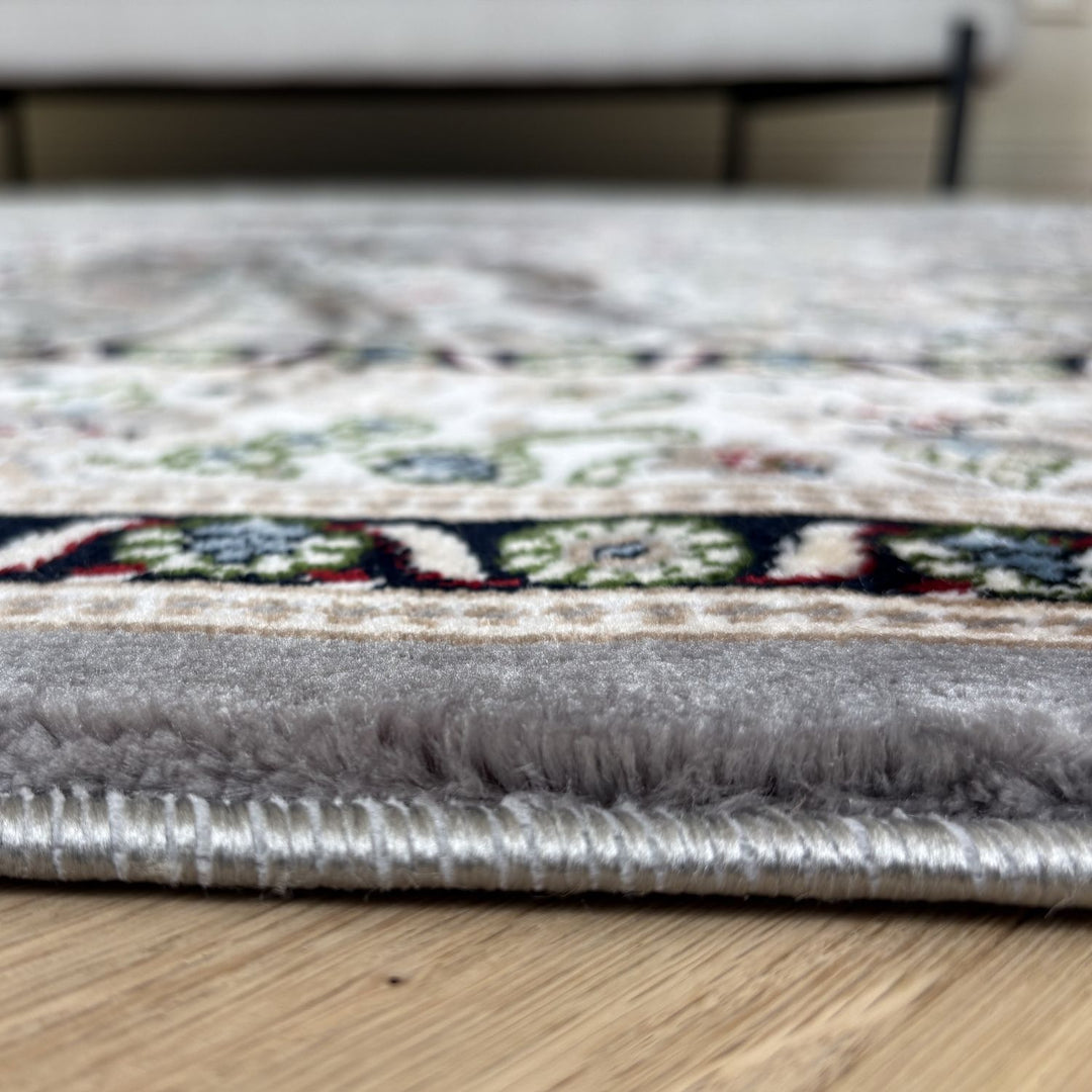 Close-up of a patterned rug on a wooden floor