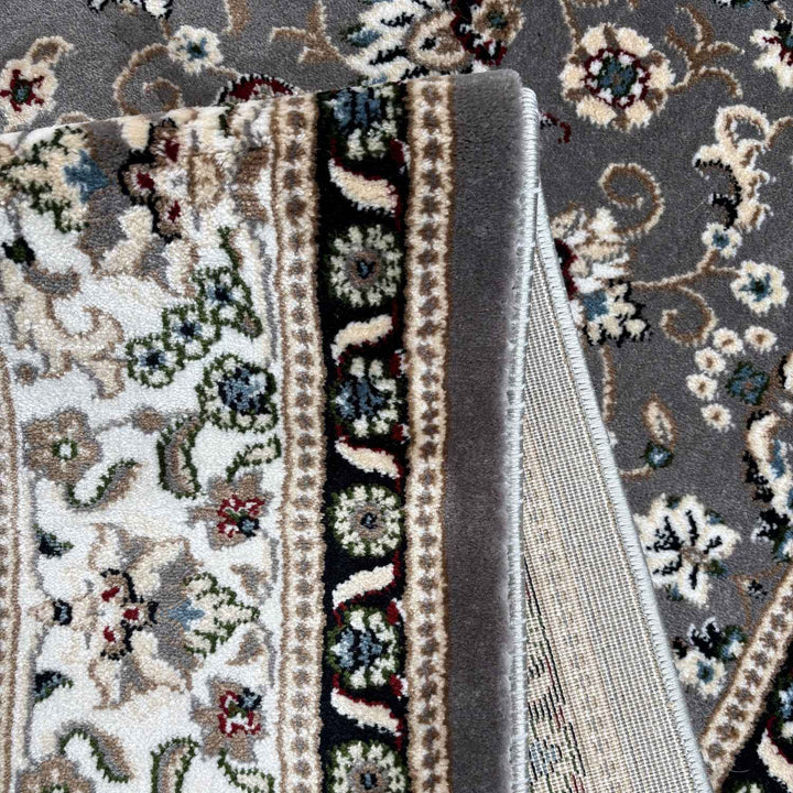Close-up of a patterned rug with intricate designs and colors.